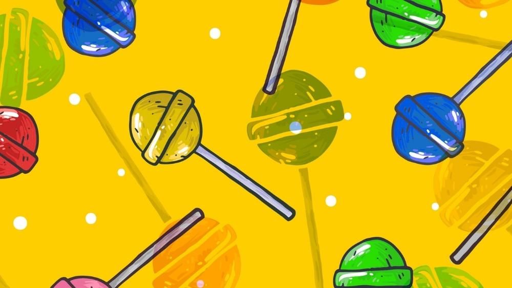 bright yellow background with brightly colored lollipops in red, green, blue, orange and yellow