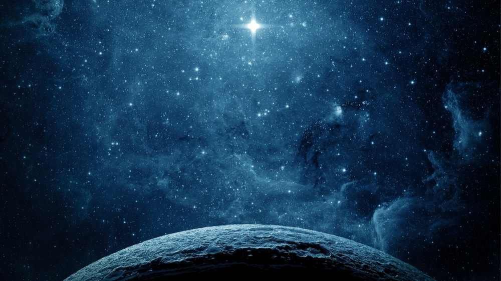 Stars shining above the earth depicting a still moment in the universe