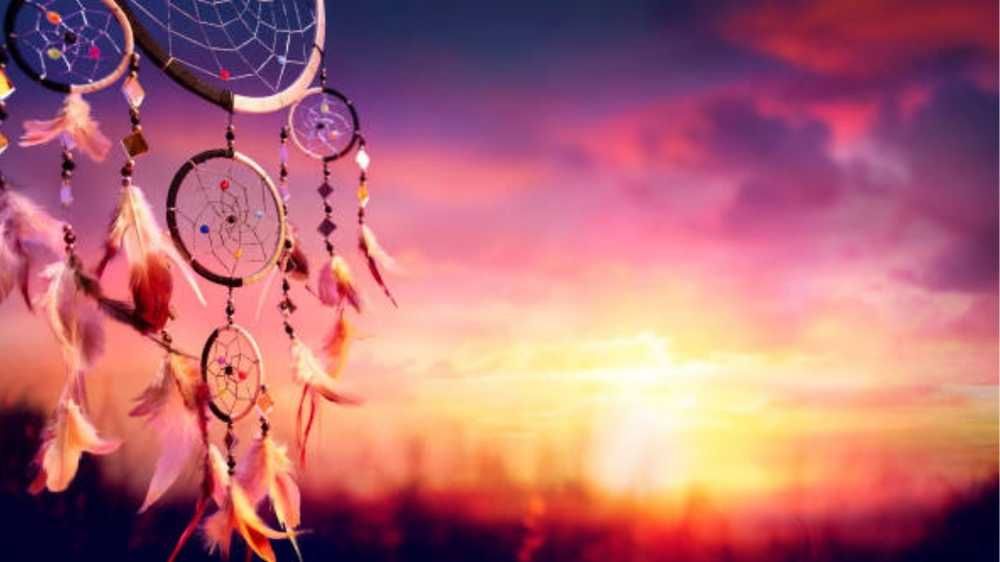 dream catcher flying in a serene pink sunset momet 