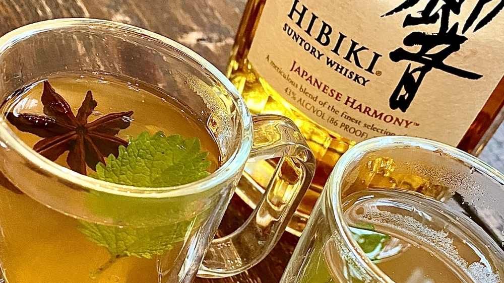 Hot Toddy served in glass mugs with Hibiki Japanese Whiskey in background