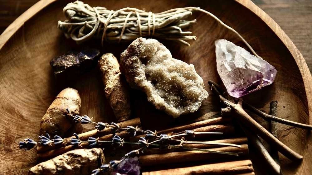 wooden tray with healing rough gemstones, lavender, sage, cinnamon, ginger and amethyst